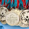 Gold medals placed on a white table.