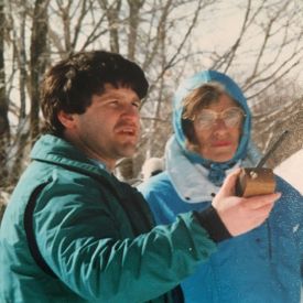 Eunice Kennedy Shriver and Beau Doherty standing outside in the snow wearing coats at the 1989 Winter games.