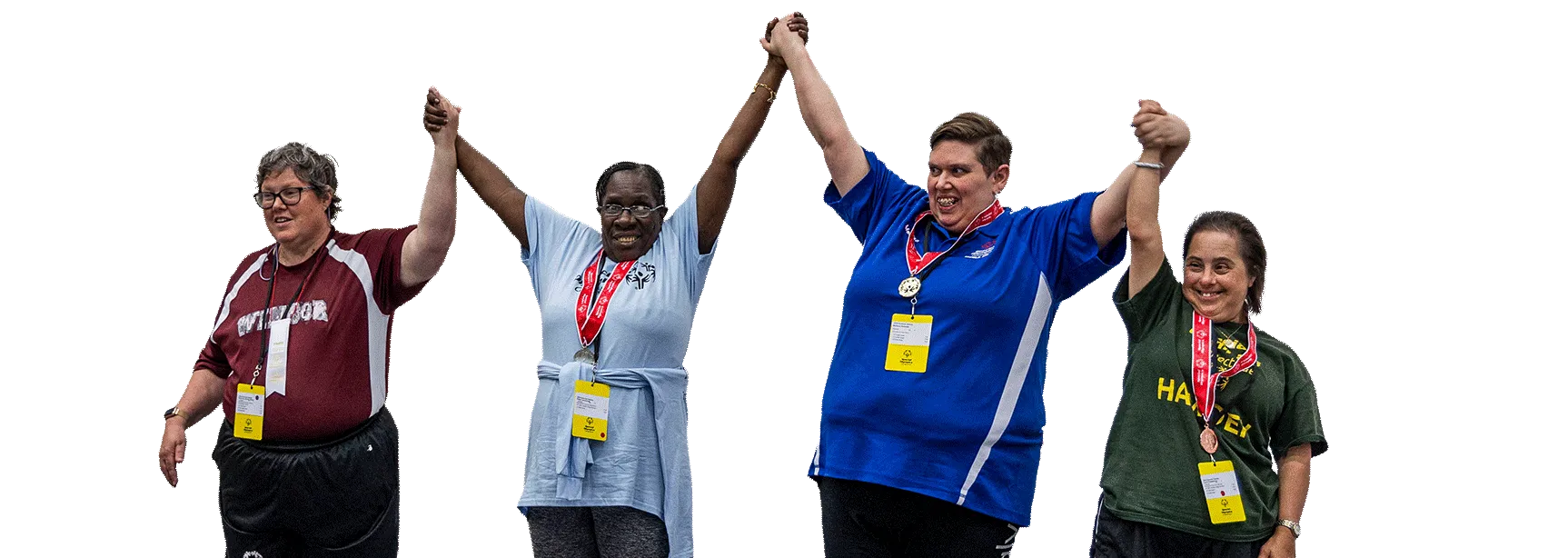 Individuals standing outside wearing white golf shirts smiling.