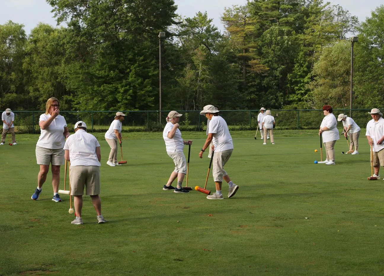 People playing bocce in field