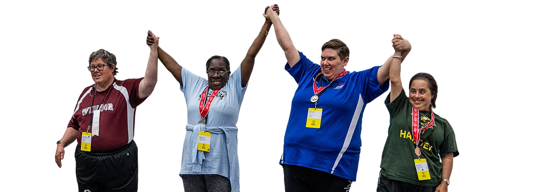 Athletes holding hands in air celebrating winning medals