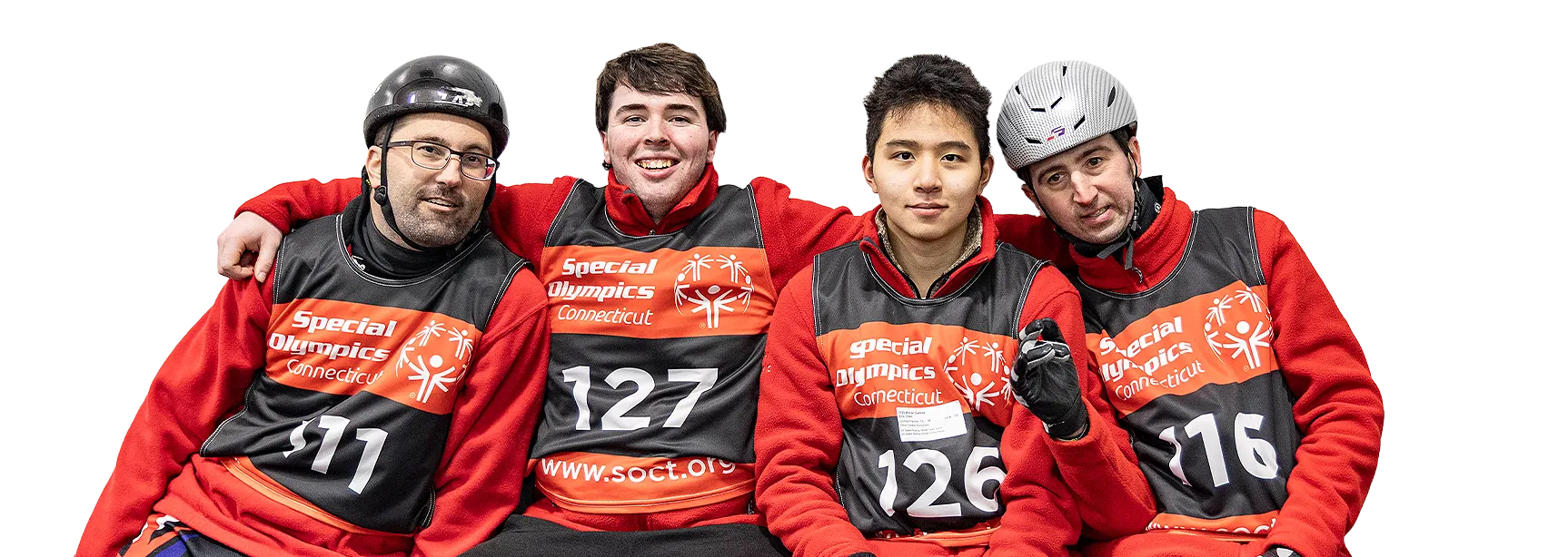 Four athletes hugging 